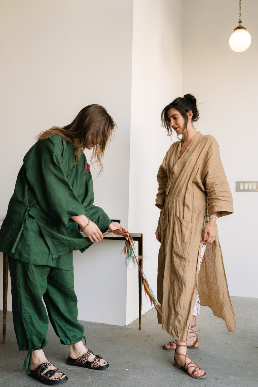 Manoela fitting a linen robe with a client