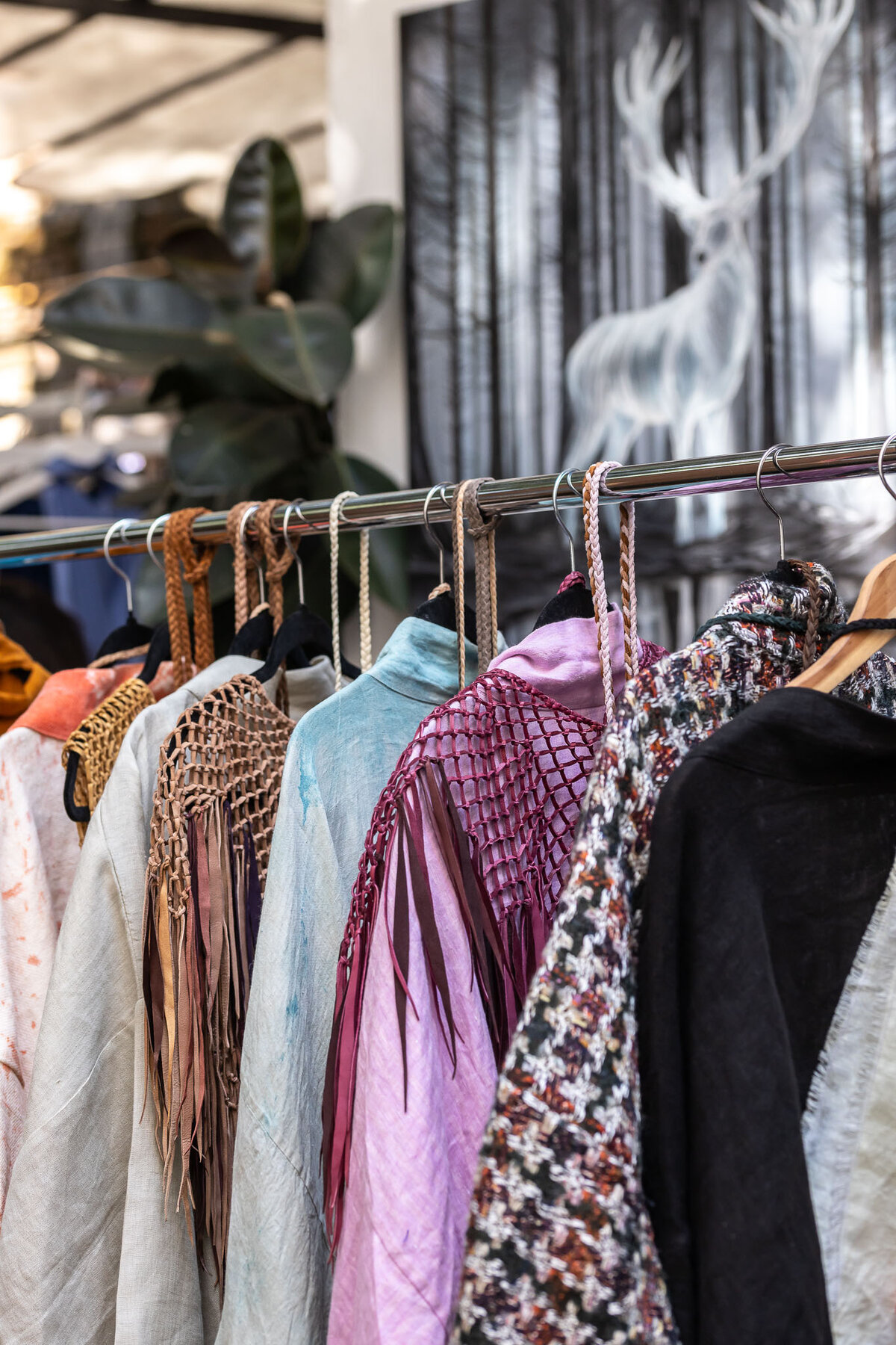 Rack of Mend a Mano robes in varied colors